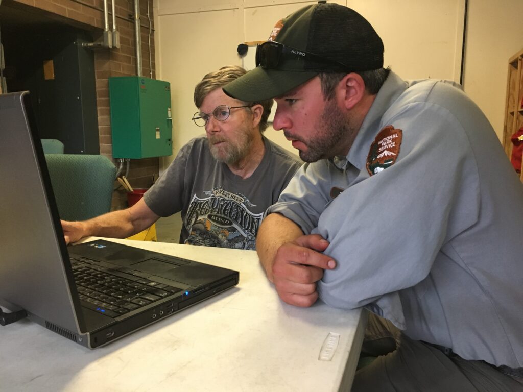 Incident response team reviewing a computer screen during an outage investigation